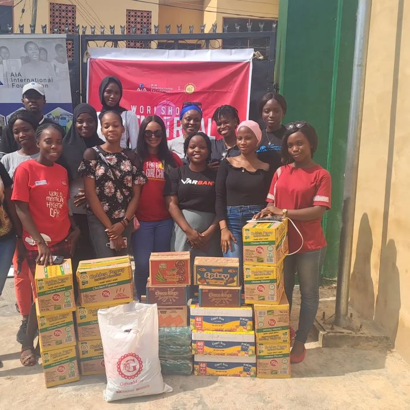 The workshop team pictured with donated supplies. AIA’s public update describes the collaboration with OVIWCE in Bodija, Ibadan.
