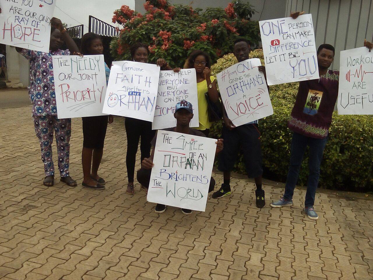 OVIWCE campaign participants holding awareness placards, from the same early-outreach feature.